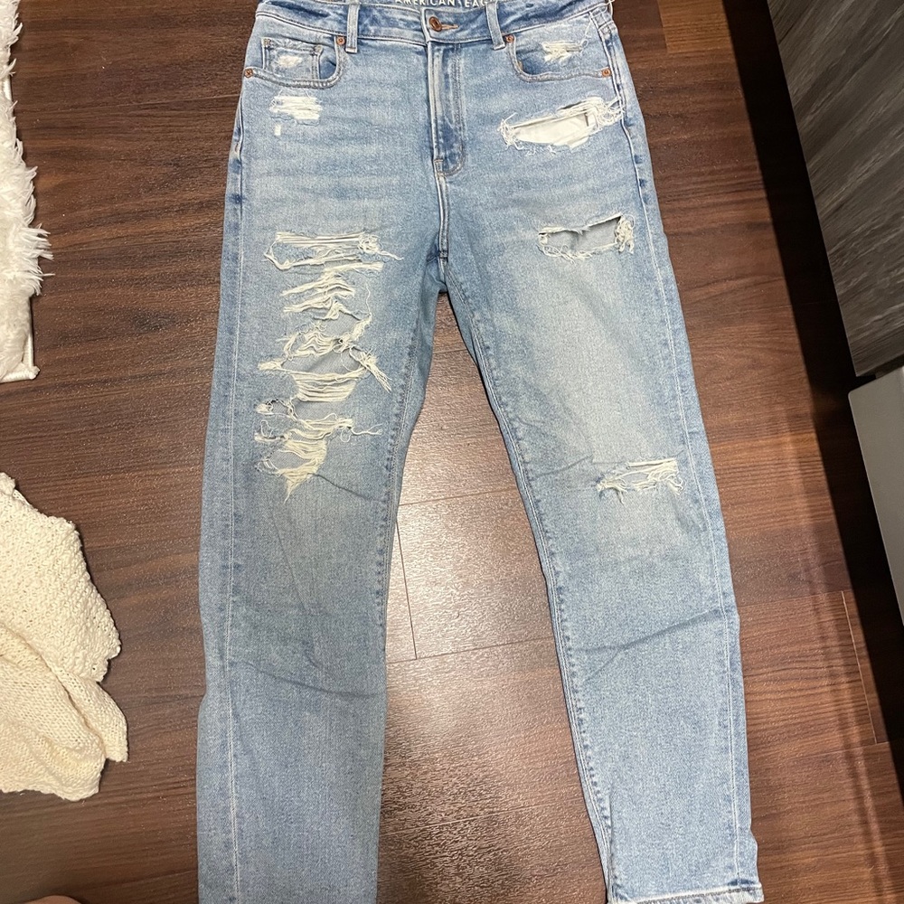 Boyfriend pair of denim jeans. Holes in the jeans.